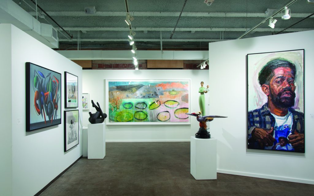 Valley House Gallery's booth was punctuated by a Valton Tyler canvas (left) and a Sedrick Huckaby portrait (right), two Texas talents in their stable that always draw interest.