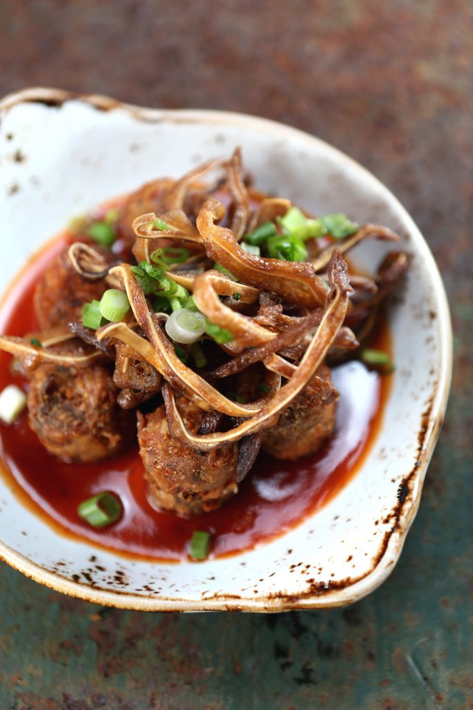 Bacon Bros.' potater tots are made in-house, then topped with crispy pig ears and the restaurant's sorghum barbecue sauce. 