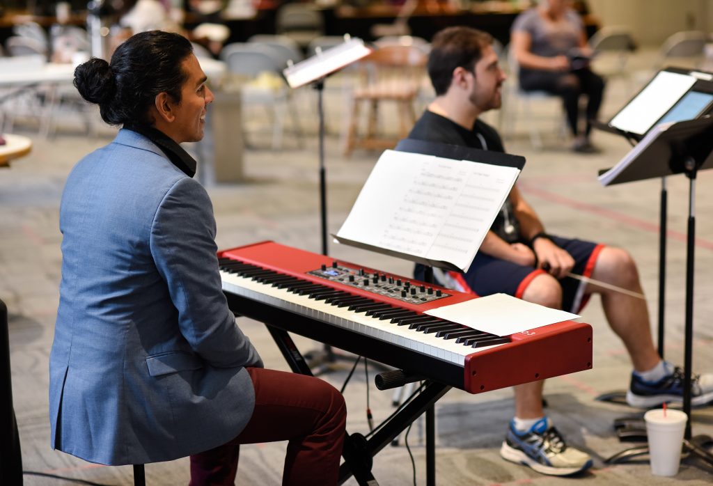 Pianist Thanushka Bandara shares a laugh at his keyboard. 