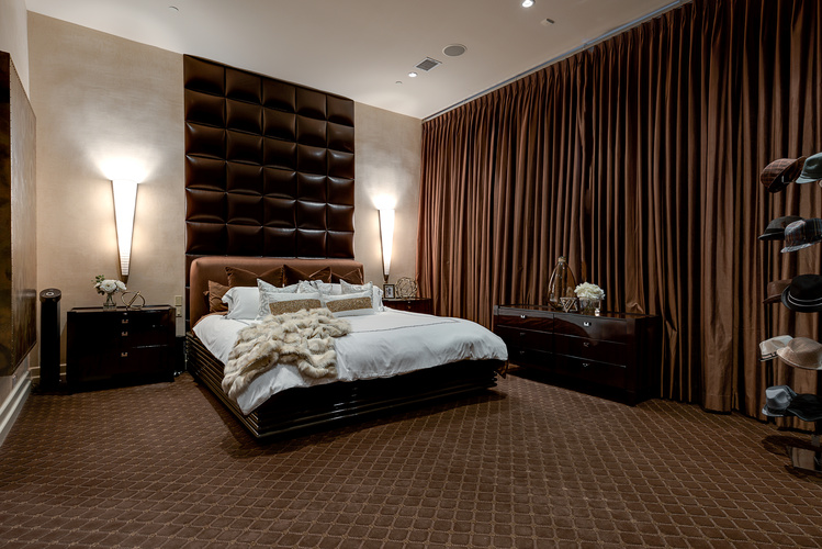 The swanky master suite is finished with neutral colors. 