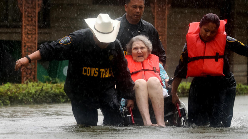 Precinct 6 Deputy Constables Sergeants Paul Fernandez, Michael Tran, and Radha Patel rescue an elderly woman from rising water on North MacGregor Way. (Photo by Jon Shapley / Houston Chronicle)