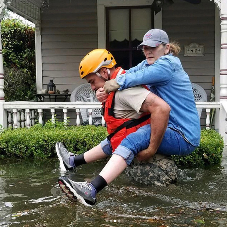 Woman rescued from flood waters via piggy back ride. (Photo collected via Instagram @therhondaross) 