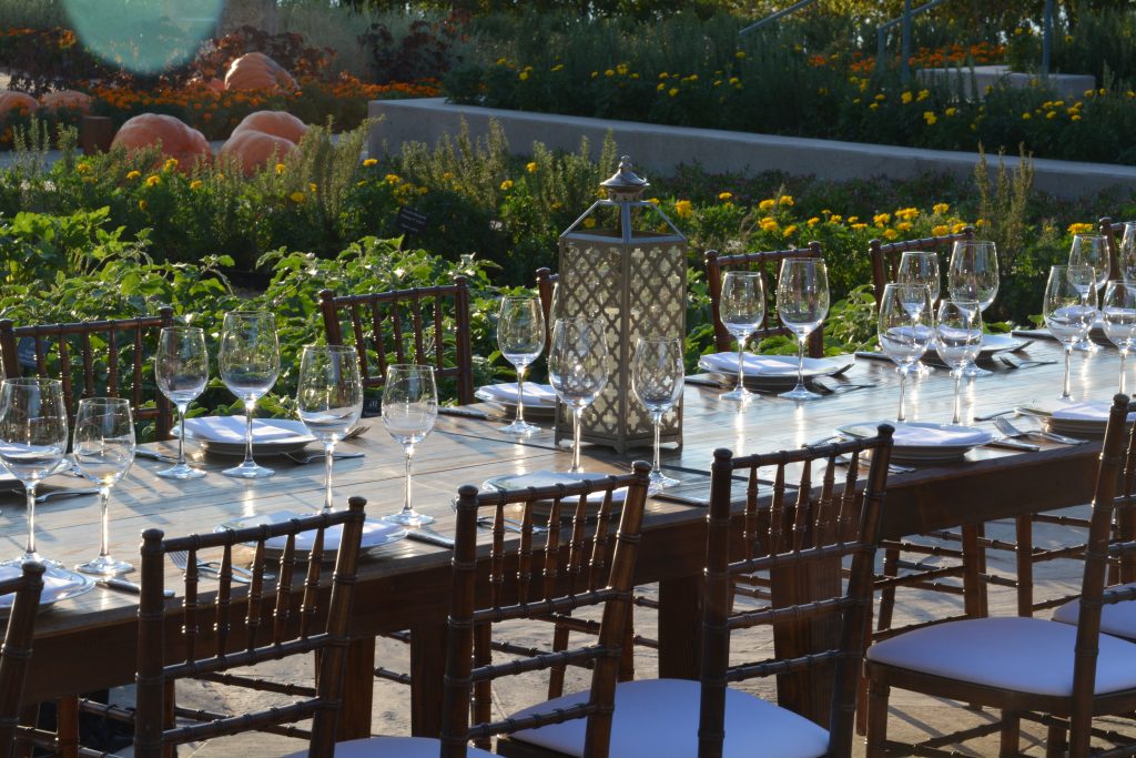 The garden accommodates a long table, perfect for outdoor events.