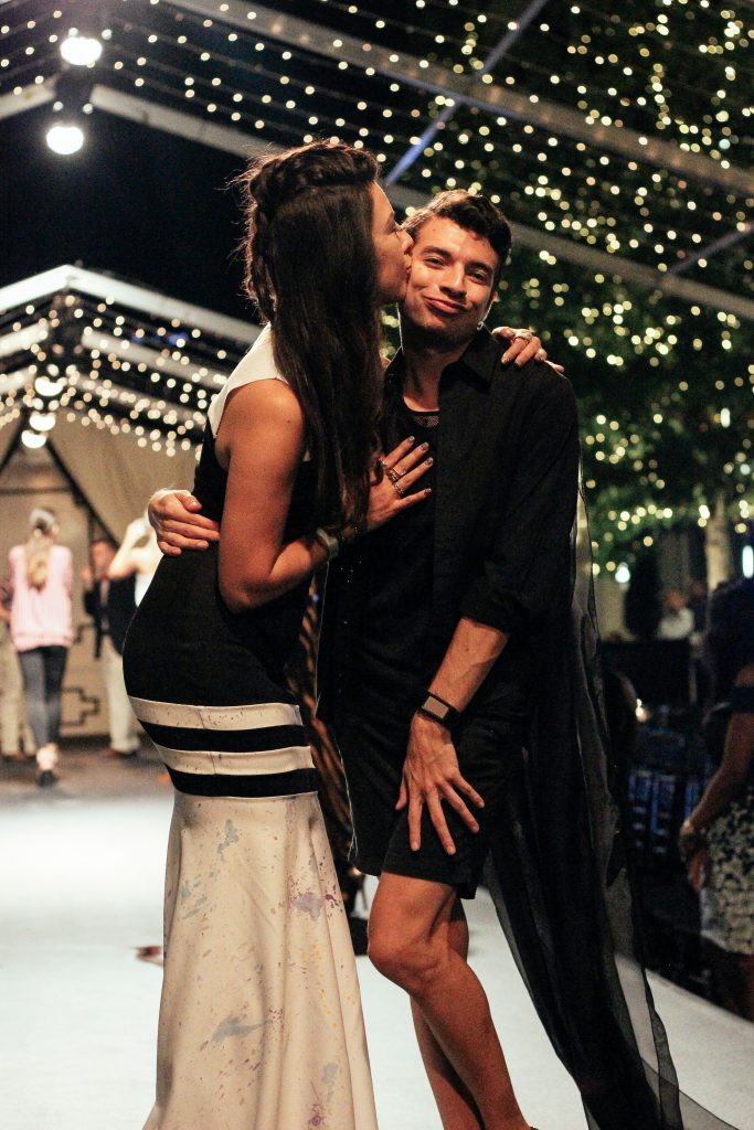 Alan Gonzalez, right, is congratulated by Anika Jackson after showing his collection at Fashion X at River Oaks District. (File photo)