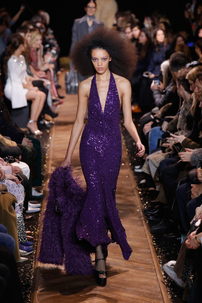 Model channels early Diana Ross in a purple sequined V-neck gown and ostrich jacket. (Photo by JP Yim/Getty Images for Michael Kors)