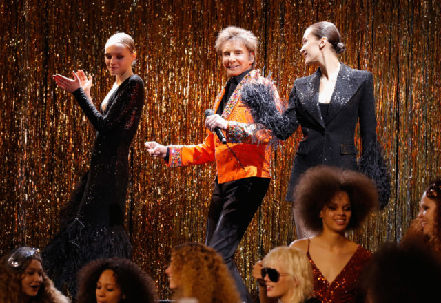 Michael Kors closed his runway show with a performance by Barry Manilow, flanked by models  Fran Summers and Bella Hadid. (Photo by JP Yim/Getty Images for Michael Kors)