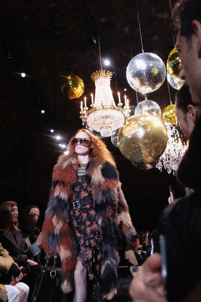 Model Kiki Willems walks the runway in a Michael Kors Collection belted floral dress and multi-color fur. (Photo by Nicholas Hunt/Getty Images for Michael Kors)