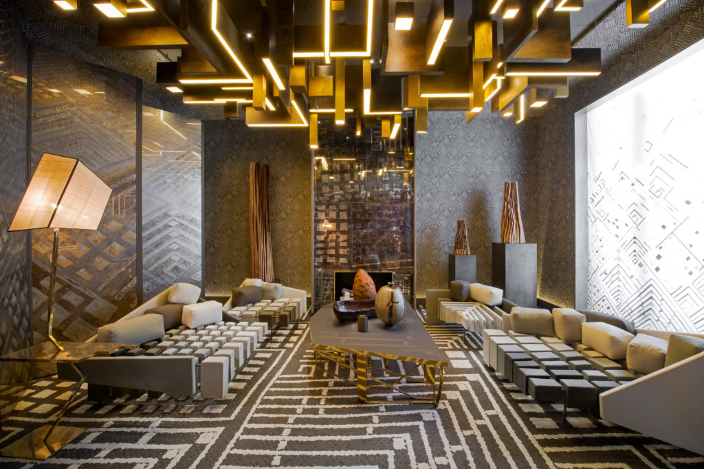 A showhouse presentation for AD Intereurs, 2012 at Artcurial, the antiques and art auction headquarters.  Antique inlaid mirror chimney piece designed by Deniot; custom sofas in 5 shaded tones by Romo, designed by Deniot and manufactured by Jean de Merry. Tai Ping Carpet.  Patinated brass and parchment chandelier designed by Deniot and made by Ombre Portee. 