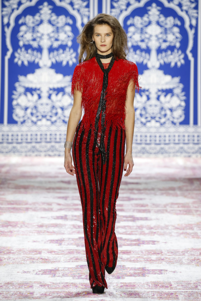 Naeem Khan red fringe cap sleeve top with flared striped sequin pant. (Photo by Naeem Khan)