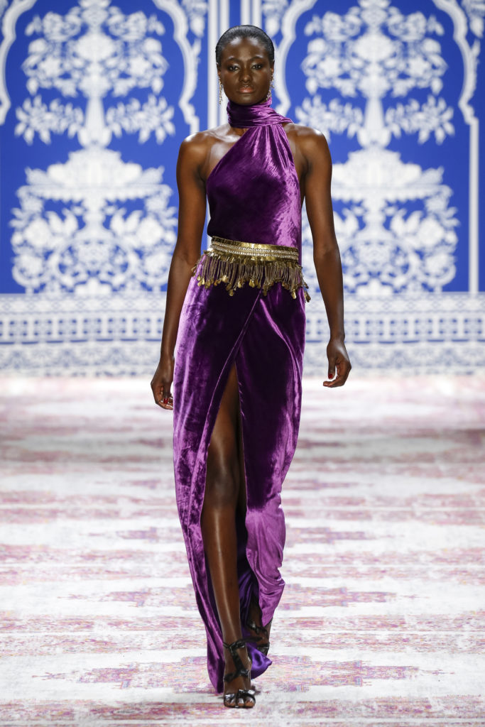 Naeem Khan purple velvet one-shoulder gown with wrap skirt and gold fringe belt. (Photo by Naeem Khan)