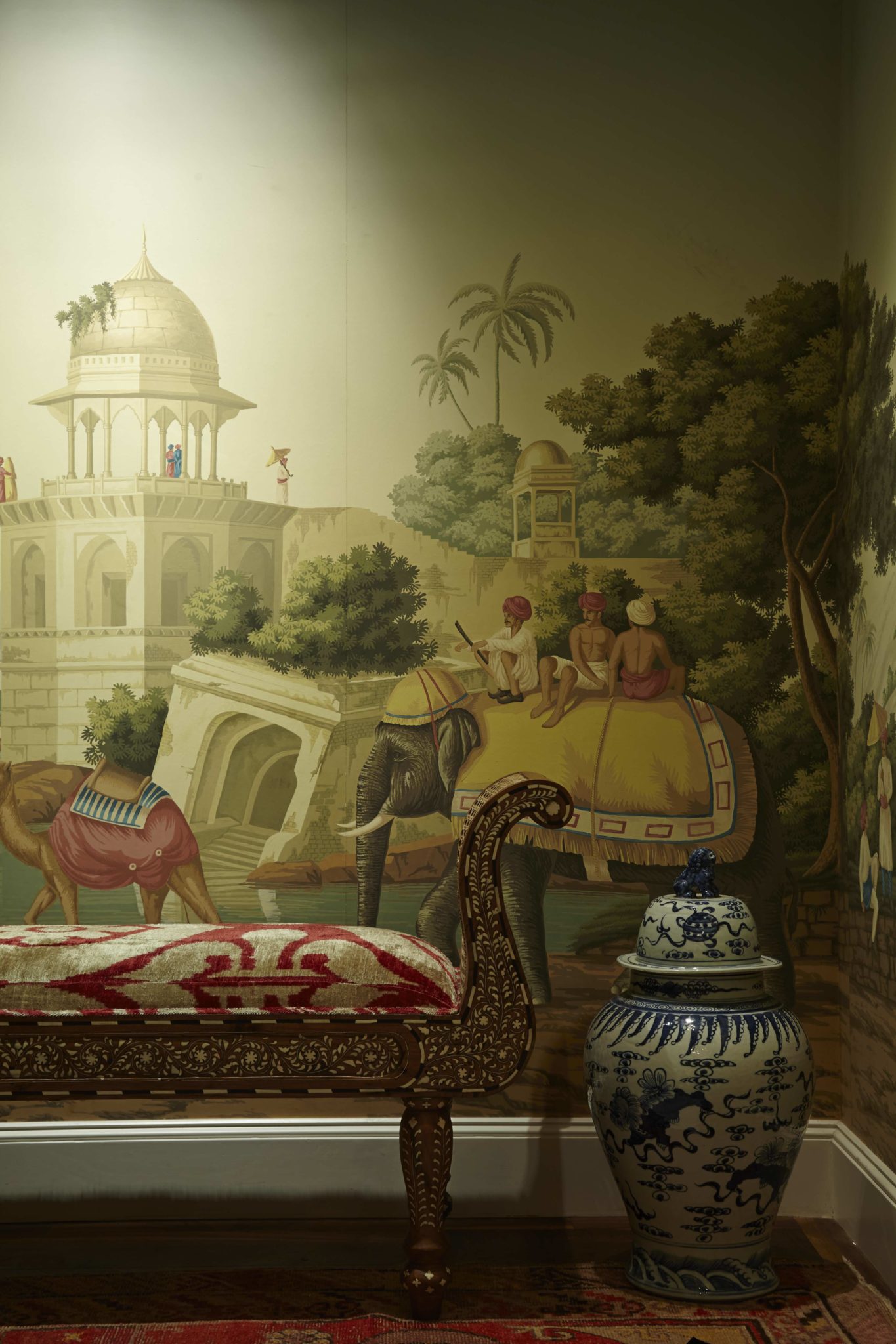 In the entryway, deGournay wallpaper. Bench from Samurai Exports, Jaipur, is covered in Seref Özen it velvet, Istanbul. Oushak rug from Abrash Rug Gallery.