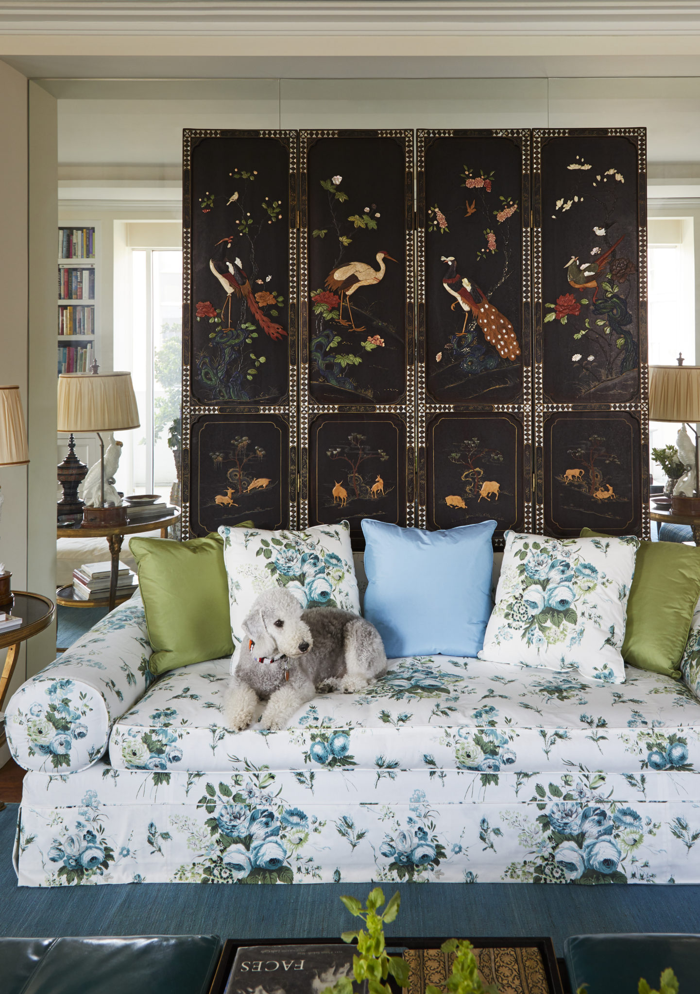 The lacquer screen was in Fine’s childhood home and brought from China in the 1950s by her uncle. GoGo sits on a sofa covered in Lisa Fine Textiles from James showroom.