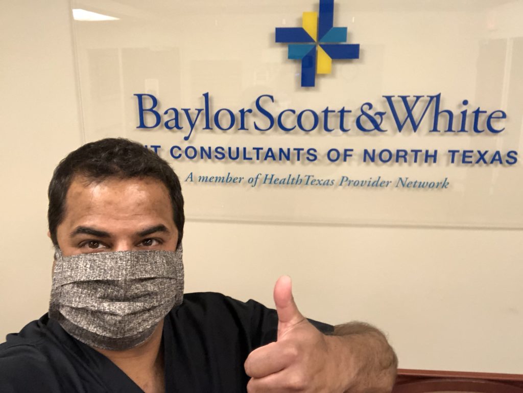 A hospital worker wearing a mask made by the refugees