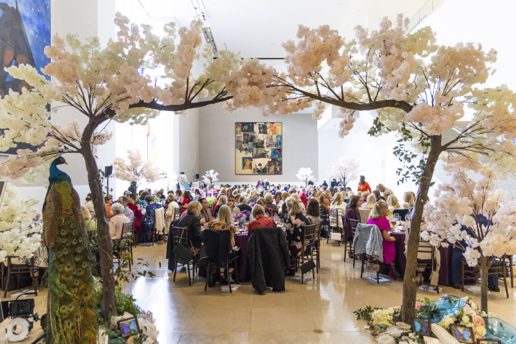 Guests enjoying the light filled atrium and awaiting the lively auction. (Photo by Kim Leeson)