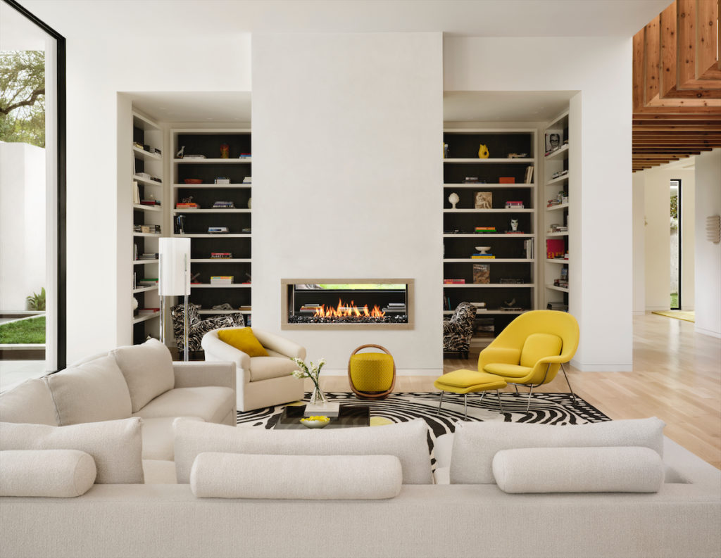 The family room's sectional sofa is designed by Julie Hayes, who also designed the rug based on a vintage one seen at a Paris flea market. Womb chair and ottoman Eero Saarinen for Knoll and Porada poof, all from Scott + Cooner. (Photo by Lisa Petrole)