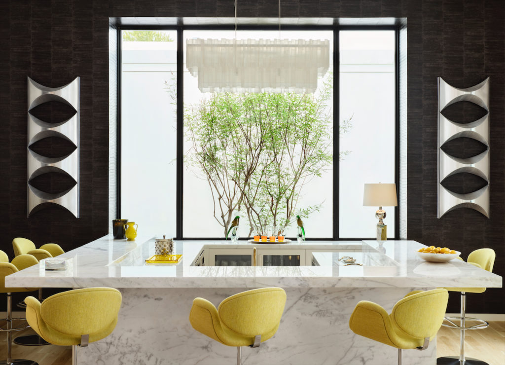 The sunken bar was designed by architect Weldon Turner. Stools by Pierre Paulin from Scott + Cooner. Sconces flanking the window are vintage from Paris. Chandelier from David Sutherland Showroom. (Photo by Lisa Petrole)
