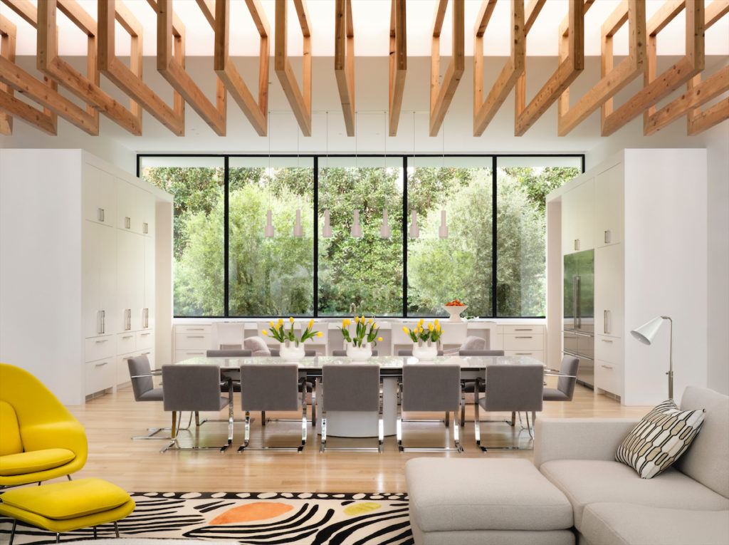 A long gallery with views outside unites the kitchen and family room. Rectangular cedar elements on the ceiling were designed by architect Weldon Turner to create warm visual interest. (Photo by Lisa Petrole)