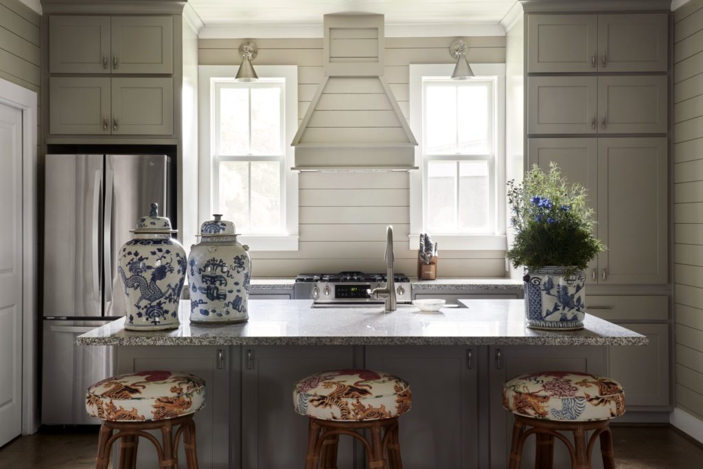 The kitchen's 1960's rattan barstools purchased at auction in West Palm Beach and reupholstered in China Seas fabric. Vintage blue and white porcelain from Lewis & Maese Antiques and Auctions. (Photo by Pär Bengtsson)