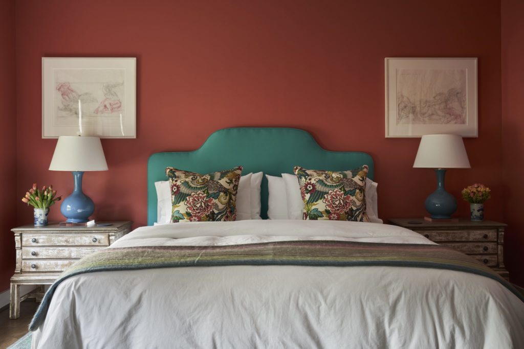 In a bedroom, watercolors are from an estate sale in Palm Beach. Headboard from Memorial Traders, Houston. Alpaca throw from Manos De Sur at Round Top Antiques & Design Center, and at The Compound during shows. On walls Sherwin Williams' Sheraton Sage. (Photo by Pär Bengtsson)