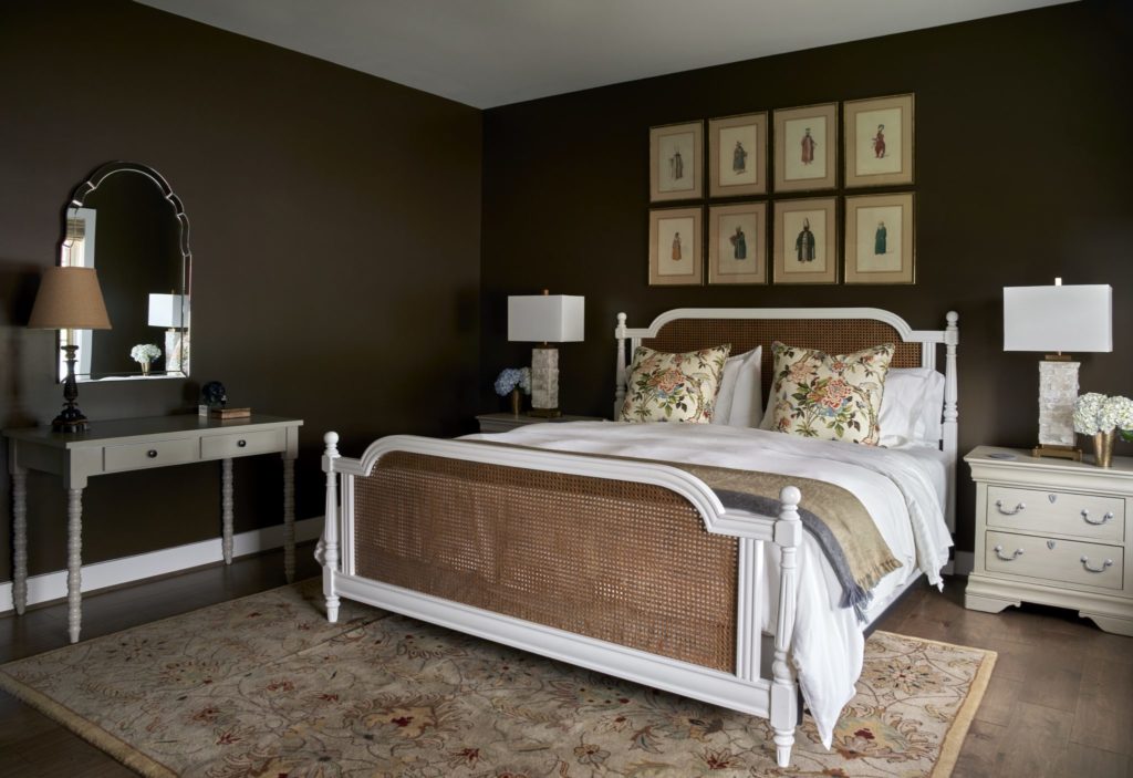 In a bedroom, engravings of emperors is from David Lackey Antiques & Fine Jewelry purchased at Big Red Barn during the shows. Walls are painted Sherwin Williams Van Dyke Brown. (Photo by Pär Bengtsson)