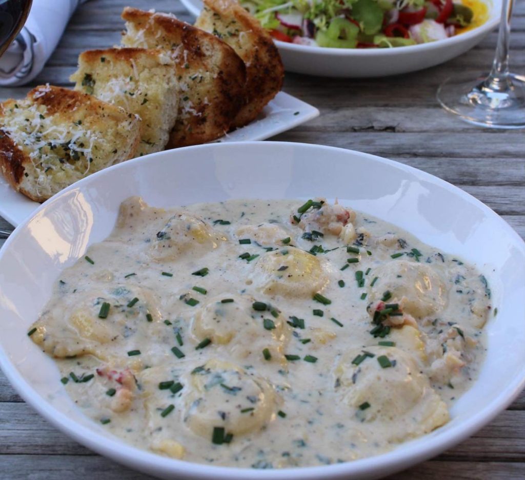 Piatello - Lobster Ravioli draped in brandy cream sauce with fresh tarragon.