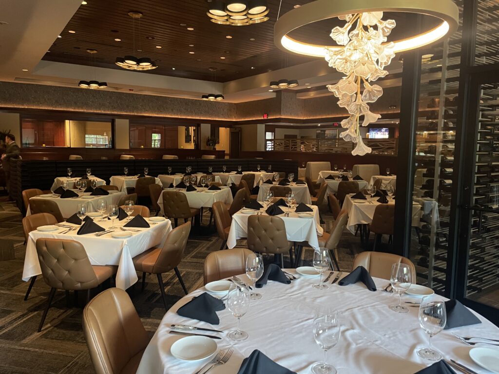 The Woodlands Fleming's floral chandelier adds to the Texas feel, next to the new glass wine area.