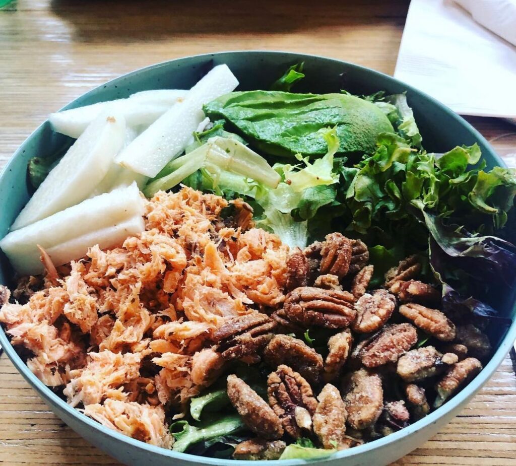 The smoked salmon salad with house made lemon truffle vinaigrette, candied pecans, jicama, and avocado on the menu at The Bearded Lady.