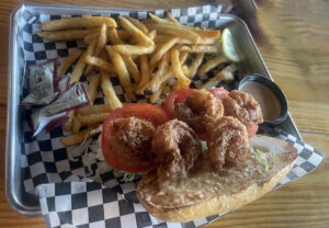 The shrimp po-boy comes with generously seasoned fries on a toasted soft roll.