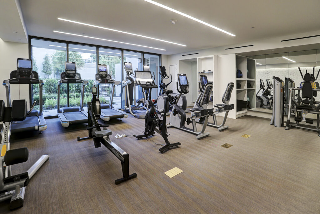 High-rise living comes with an array of amenities and luxurious offerings, including state-of-the-art gym equipment.