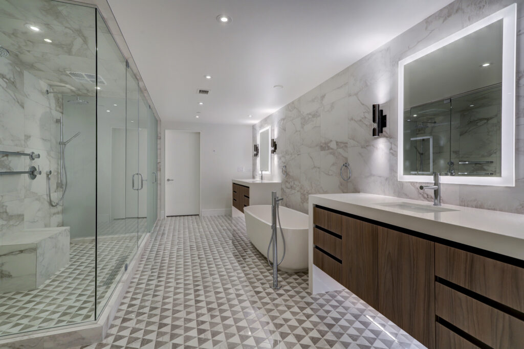 The home boasts extravagant spa bathrooms like this top floor primary bathroom draped in Piemme Italian tile