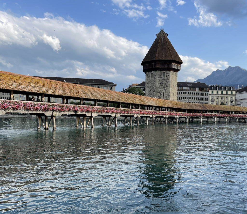The Kapellbrücke (literally, Chapel Bridge) is a covered wooden footbridge that is an iconic part of Lucerne's town center in the Swiss Alps.