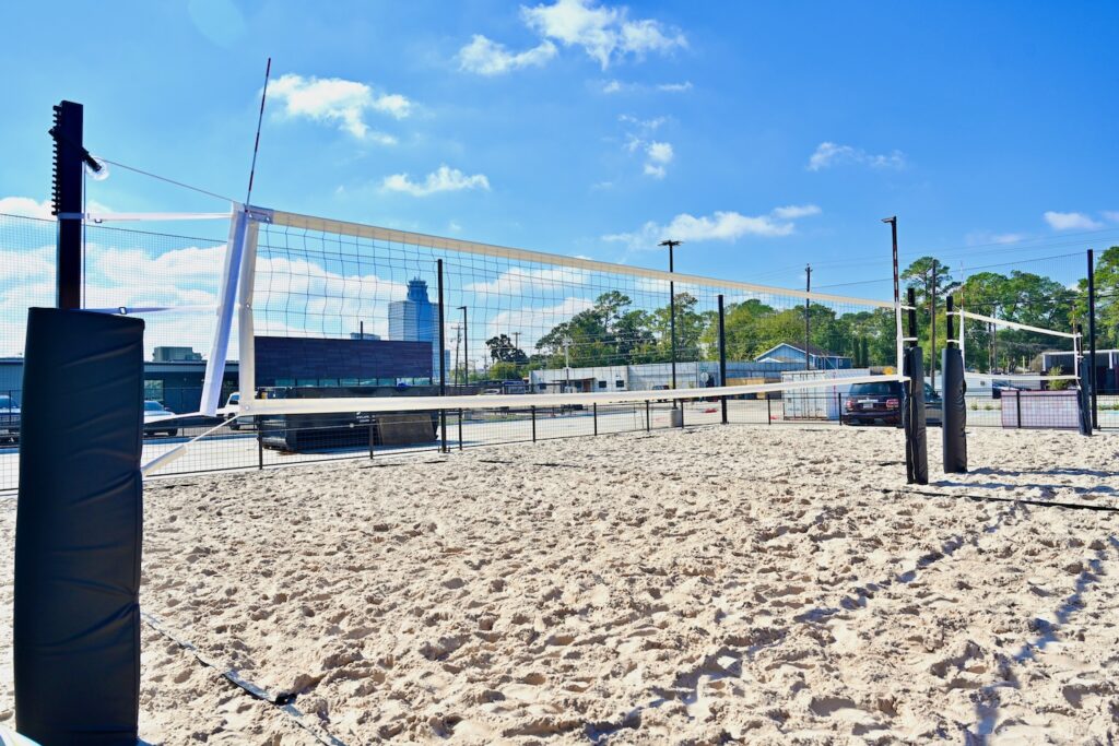 The new bar The Decoy features a trio of sand volleyball courts, cornhole and yard games. (Photo by Alex Montoya)