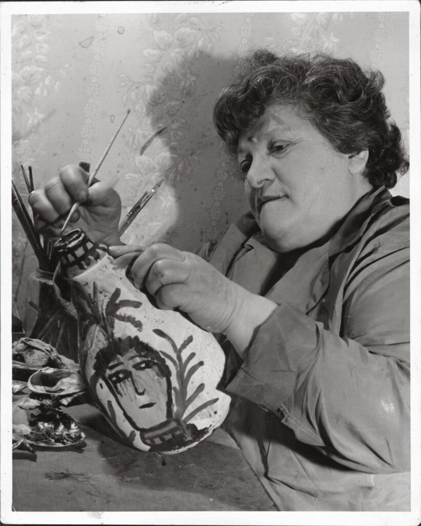 Artist Janet Sobel paints one of her artworks.