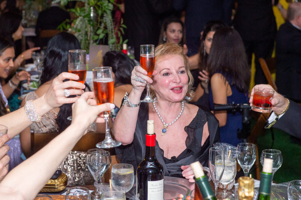 Diana Skerl at the Junior League of Houston Charity Ball enjoys a toast. (Photo by Jacob Power)