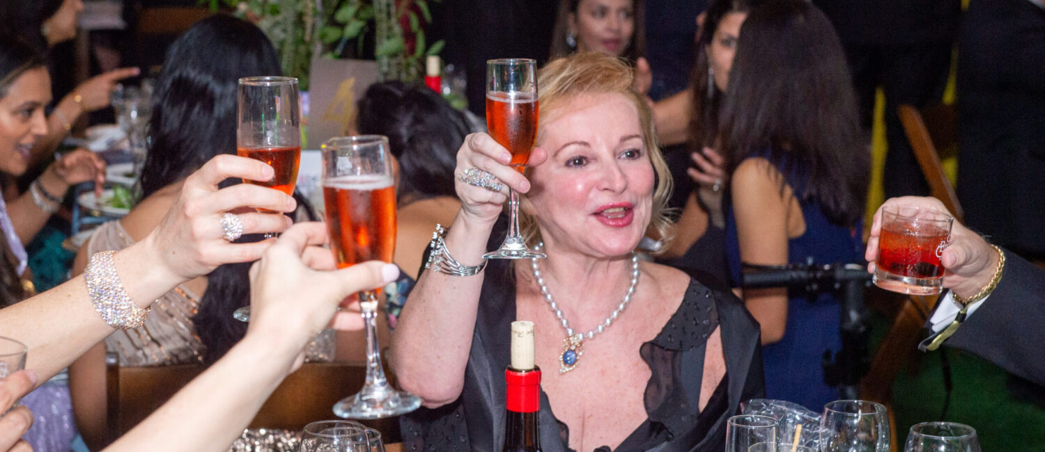 Diana Skerl at the Junior League of Houston Charity Ball enjoys a toast. (Photo by Jacob Power)