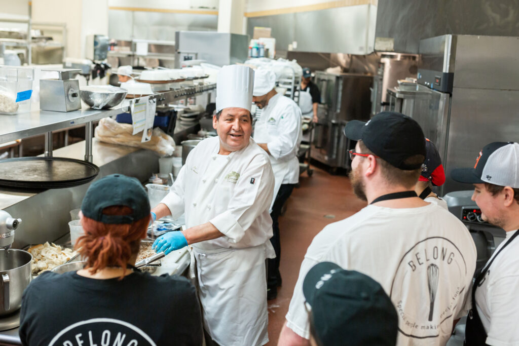 Some of the talented team works with Brennan's chef José Arévalo at Belong Kitchen. (Photo by Marlo Wise)