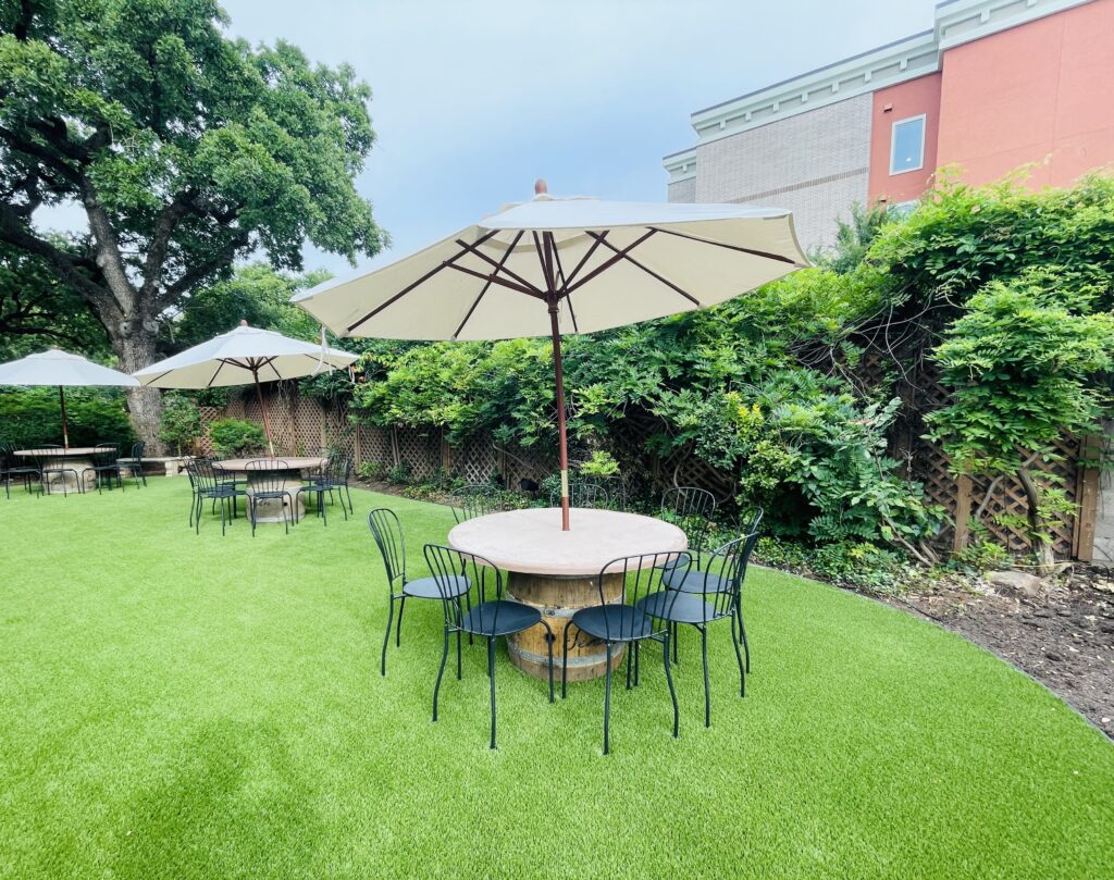 Wine barrels become relaxing wine-tasting tables in the backyard at Saddlerock Wine + Beer Co. (Photo by Courtney Dabney)