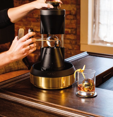 The Monogram forge heated ice press makes craft ice spheres one after another. 