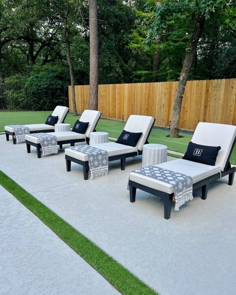 Four lounge chairs and side tables in black and white keep the deck sleek and modern.