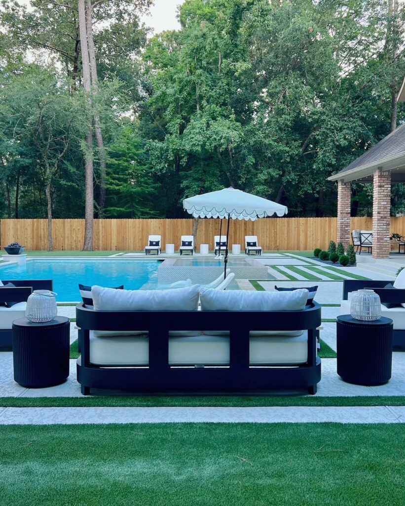 A cool deck surface keeps the steps from porch to pool from becoming too hot in this Woodlands Style House design.