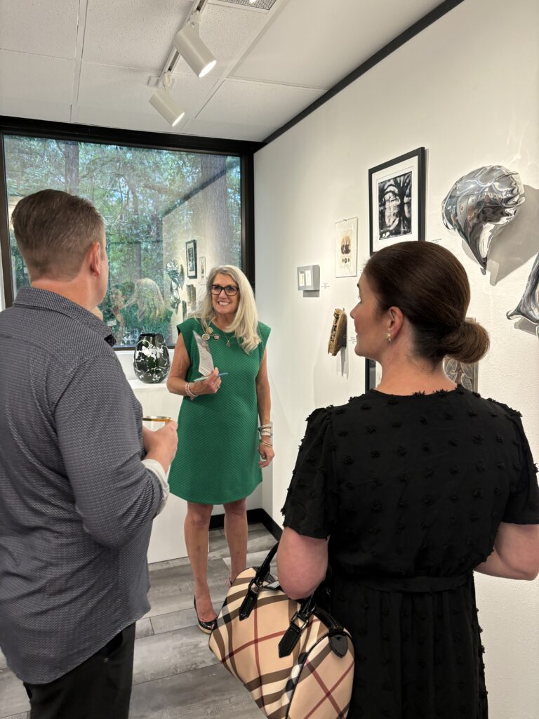 Artist Jayla Ash Davis, center, talks about art in her collection with Keith Verville and Ardest Gallery owner Julie Verville at preview event. (Photo by Laura Landsbaum)