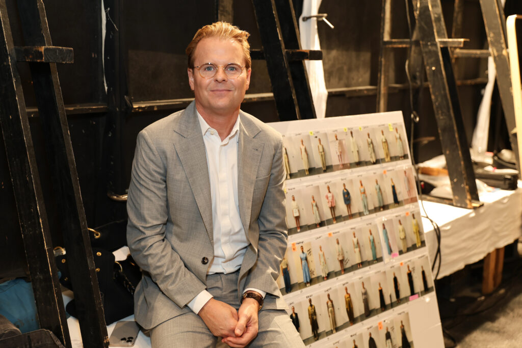 Designer Adam Lippes backstage at the PaperCity Philanthropy in Fashion Best Dressed luncheon preparing for the Neiman Marcus fashion presentation.