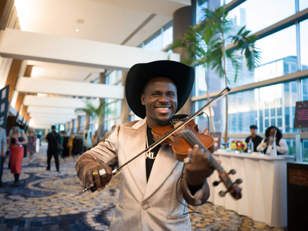 Electronic violinist Demola at the Houston Cattle Baron's Ball. (Photo by Daniel Ortiz)