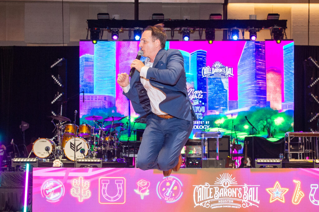 Johnny Bravo jumps for bids at the Houston Cattle Baron's Ball. (Photo by Jacob Power)