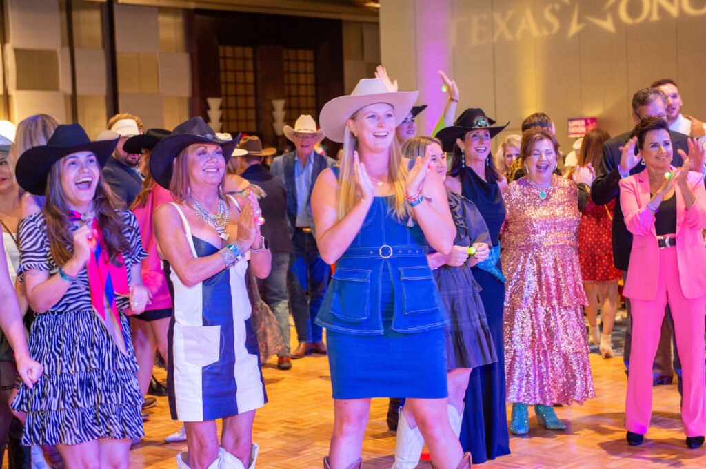Attendees play a rousing game of heads or tails. (Photo by Jacob Power)