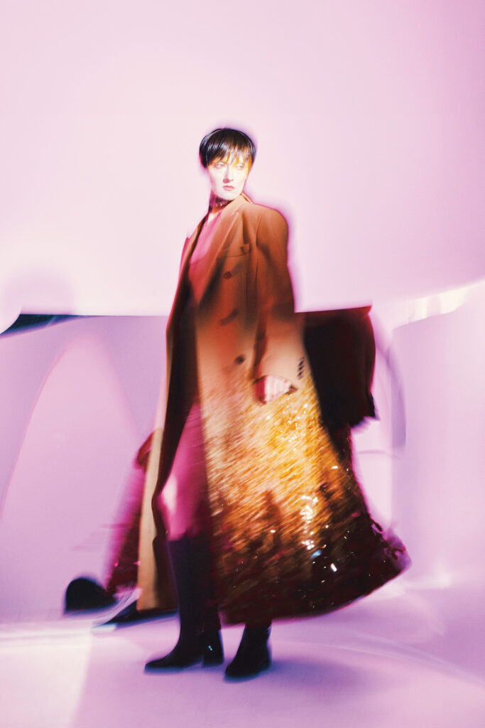 Gucci double-breasted wool coat $20,000, wool top $2,700, wool crepe short pant $1,700, silk ribbon $520, stud choker $2,950, and leather boot $3,500, at select Gucci boutiques, farfetch.com, net-a-porter.com.  (Photo by Fernando Rodriguez)