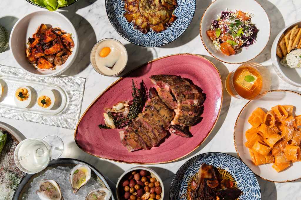 An array of shareable dishes is served at the new Maven at Sawyer Yards. (Photo by Becca Wright)