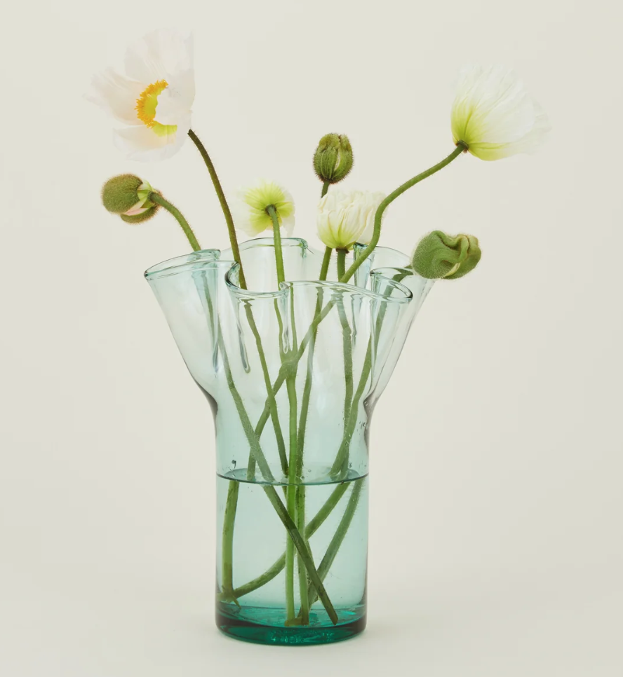 The Recycled Donaire Glass Vase is made from repurposed glass, featuring a one-of-a-kind design that adds a touch of artistry to any room. (Photo courtesy Hawkins New York)