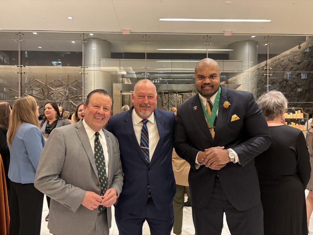 Visit The Woodlands CEO Nick Wolda (left), TWHS Athletic Director and Head Football coach Jim Rapp, and Hometown Hero and former Oakland Raider Grant Irons, Jr. at the Hometown Heroes reception on November 6 at the Howard Hughes tower. (Photo by Laura Landsbaum)