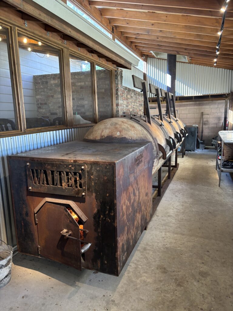 The pit room at Tejas Chocolate + Bar-B-Q has three large smokers: Walter, Donnie and Dude. (Photo by Laura Landsbaum)